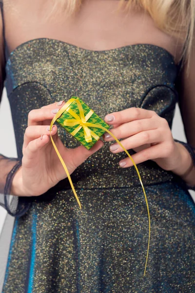 gift in the hands of a girl, beautiful dress, festive mood, concept