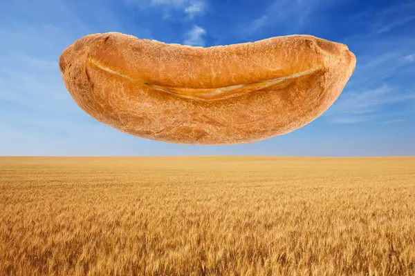 Loaf Bread Smiling Mouth Levitates Blue Sky Ripe Yellow Wheat — Stock Photo, Image