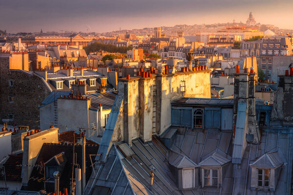 Parisian roofs of Montparnasse and Montmartre at golden sunset Paris, France