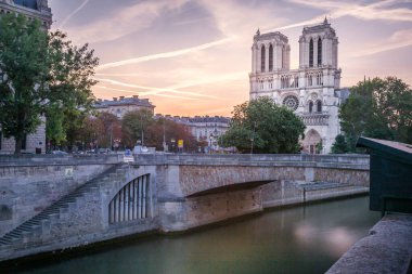 Notre Dame Cathedral of Paris and Seine river at dramatic sunrise, France