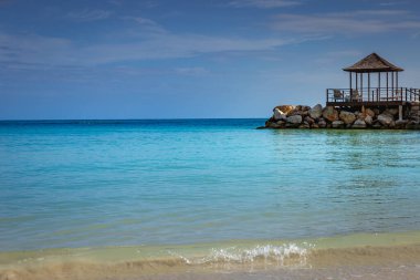 Tropical paradise: idyllic caribbean beach with pier and gazebo, Montego Bay, Jamaica