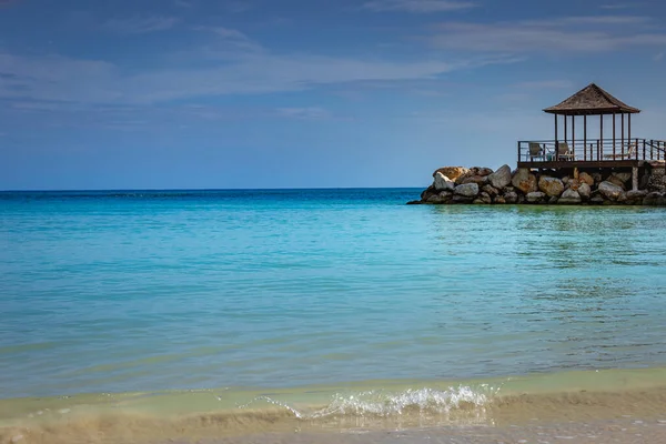Tropical paradise: idyllic caribbean beach with pier and gazebo, Montego Bay, Jamaica
