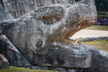 Chichen Itza kukulcan snake with lizard reptile in the open mouth, Ancient Mayan civilization, Mexico