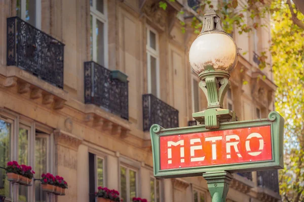 Retro Paris Metro sign entrance in Montmartre, Paris at sunset, France