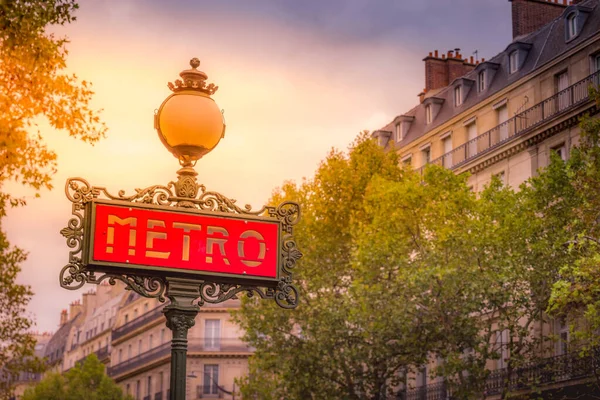 Retro Paris Metro sign entrance in Montmartre, Paris at sunset, France