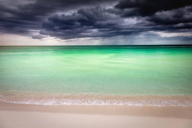 Dramatic sky with storm clouds over caribbean beach, Negril Seven Mile Beach, Jamaica