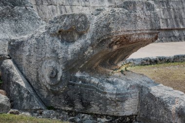 Chichen Itza kukulcan snake with lizard reptile in the open mouth, Ancient Mayan civilization, Mexico