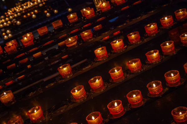 row of tea light candles burning inside Notre Dame Cathedral in Strasbourg, Eastern France