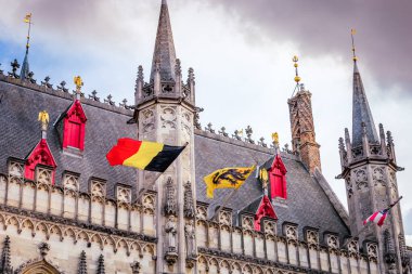 Belgian and euro flags with flemish architecture in Bruges
