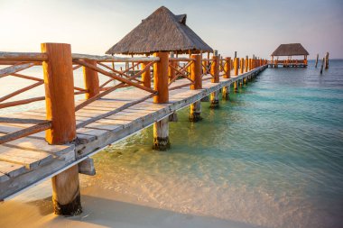 Tropical paradise: Cancun idyllic caribbean beach with with rustic palapa pier, Riviera Maya, Mexico