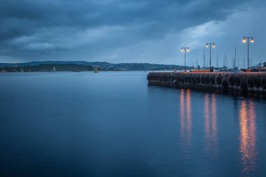 Oslofjord at evening with dramatic sky and pier, Oslo, Norway, Scandinavia