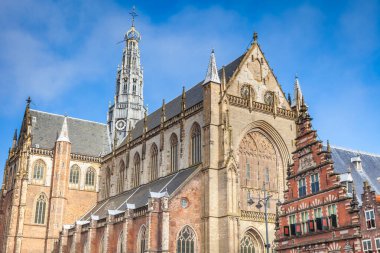 Amsterdam clock tower, cathedral and dutch architecture at sunny day, Netherlands