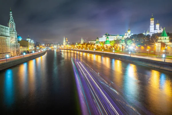 Kremlin towers illuminated at evening with river Moscva reflection, Moscow, Russia