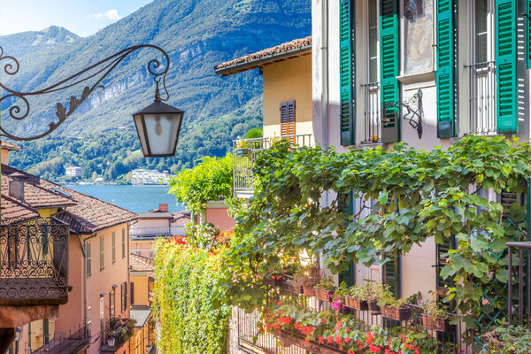 Colorful old town street with springtime balcony in Bellagio, Northern Italy