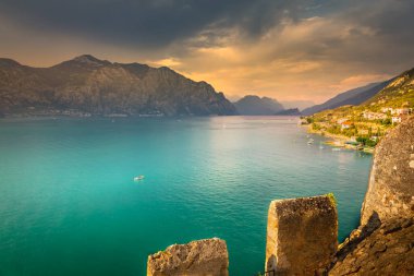 Above idyllic Lake Garda in Malcesine at dramatic sunset, northern Italian alps