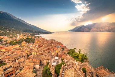 Above idyllic Lake Garda in Malcesine at dramatic sunset, northern Italian alps