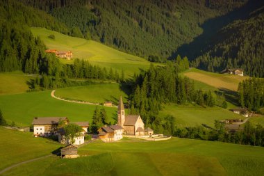 St. Magdalena village with famous church in Val di Funes at sunset, Dolomites , Italy