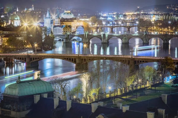 Above Prague old town bridges and river Vltava at dramatic night, Czech Republic