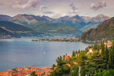 Village and sailboats on Lake Como near Bellagio at sunset, northern Italy