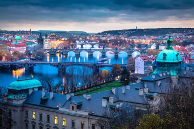Above Prague old town bridges and river Vltava at dramatic dawn, Czech Republic
