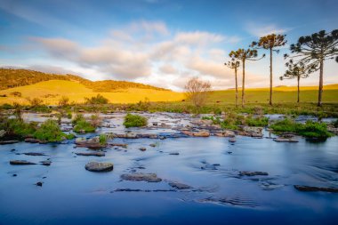Southern Brazil, Sao Jose dos Ausentes countryside and river landscape at peaceful golden sunset, long exposure