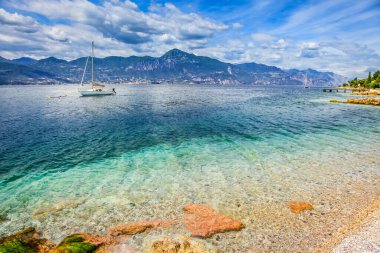 Kuzey İtalya 'da yelkenli ve dağları olan Malcesine' deki Idyllic Gölü Garda sahili.