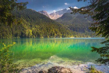 Idyllic Lake Tovel reflection symmetry in Trentino-Alto Adige, Italy