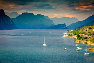 Above idyllic Lake Garda in Malcesine at dramatic sunset, northern Italian alps