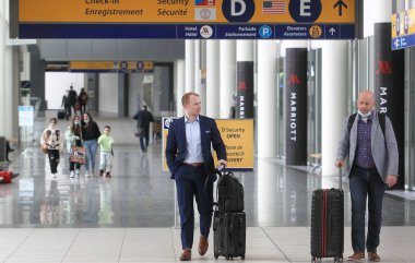 Calgary, Alberta, Canada - May 17 2022: Travelers at with luggage Calgary's International Airport. 