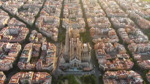 スペインのカタルーニャ州バルセロナにあるサグラダ ファミリア大聖堂の空中写真 日の出にガウディの建築の傑作を飛び回る — ストック動画