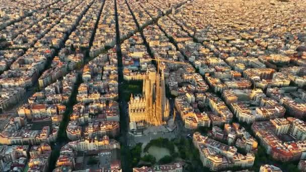 バルセロナ市内のスカイラインとサグラダ ファミリア大聖堂の空中ビュー 住宅の有名な都市グリッドの例 典型的な都市八角形のブロックを持つ都市景観 スペインのカタルーニャ — ストック動画