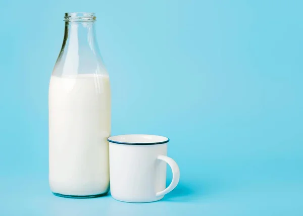 Milk in a Glass Bottle and a White Cup