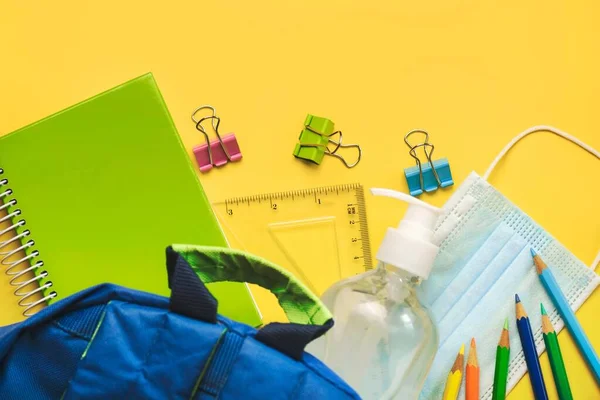 School Supplies with Medical Mask and Sanitizer Bottle.Selective