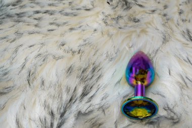 sexy butt ass plug on the gray fur background, adult store concept 