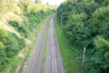 railway tracks on the road, view from above on the railway road, travelling, direction of way 