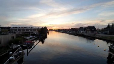 beautiful sunset over the river canal in Amsterdam, view on the city at dusk