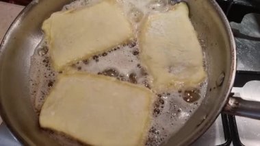 frying pies, pastry, patty, dough in oil on frying pan in the kitchen 