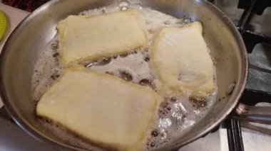 frying pies, pastry, patty, dough in oil on frying pan in the kitchen 