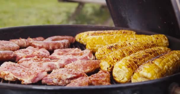Ribs Sausages Grilled Sweet Corn Steaming Barbecue Fire Friends Having — Stockvideo