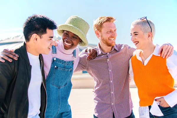 Group of four friends laughing out loud outdoor. Two couples talking and enjoying a good day.High Quality Photo