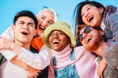 young people laughing out loud on a sunny day enjoying vacation together. high quality photo