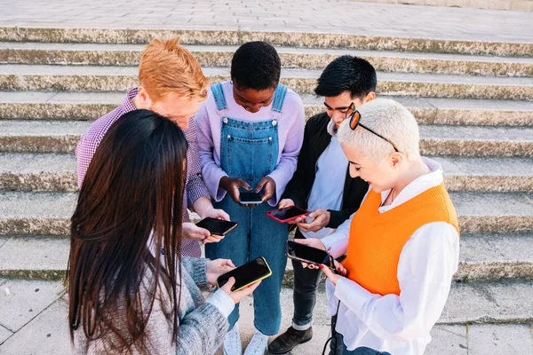 group of friends chatting and browsing with smartphones in a group. high quality photo
