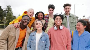Group Of happy multiethnic Teenage friends smiling and laughing at College Building. A lott of students standing at the university campus. High quality 4k footage