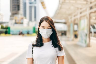 Young adult business asian woman wear face mask for protect virus corona or covid19 and air pollution. Urban people lifestyle with public health on day concept. Women portrait looking camera.