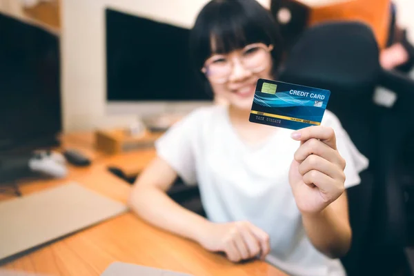 Credit card for pay and shopping online via internet technology at home concept. Blur people holding background.