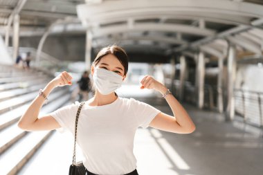 Happy young adult business asian woman wear face mask for protect virus corona or covid19 and air pollution. Urban people lifestyle with public health on day concept. Women portrait looking camera.