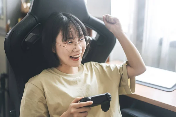 sexy Asian woman play game online on smartphone and smile Stock Photo