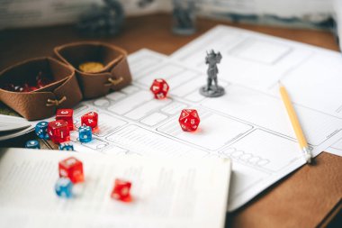 Role playing tabletop and board games hobby concept. D20 dice place on character sheets for create begin fantasy and adventure. Background with book and miniatures. clipart