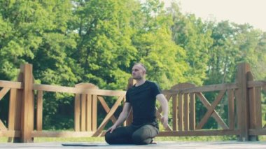 Exercises to strengthen back muscles. Relaxing fitness training. Training session in the forest.