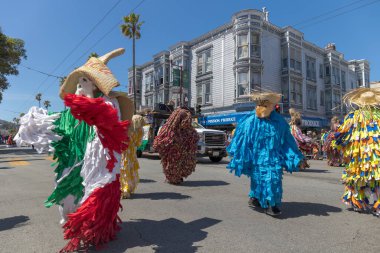 The outfits worn by the men are called tiliches. Made with pieces of colorful fabric, these costumes date back to the 19th century when people celebrated the expulsion of French invaders from the